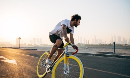 a man riding a bicycle on a road