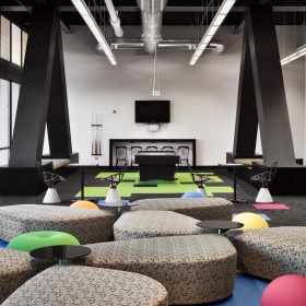 a room with a couch and chairs